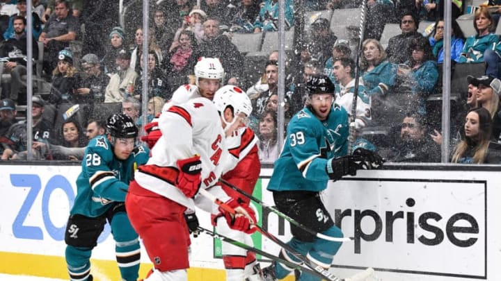 SAN JOSE, CA - OCTOBER 16: Timo Meier #28 and Logan Couture #39 of the San Jose Sharks battle for the puck against the Carolina Hurricanes at SAP Center on October 16, 2019 in San Jose, California. (Photo by Brandon Magnus/NHLI via Getty Images)