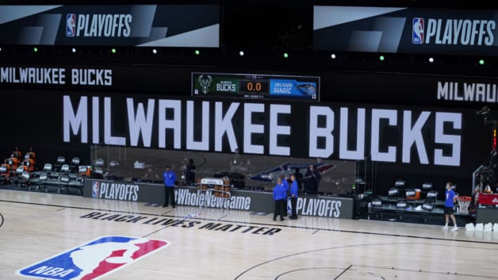LAKE BUENA VISTA, FLORIDA - AUGUST 26: Officials stand beside an empty court after the scheduled start of game five between the Milwaukee Bucks and the Orlando Magic in the first round of the 2020 NBA Playoffs at AdventHealth Arena at ESPN Wide World Of Sports Complex on August 26, 2020 in Lake Buena Vista, Florida. According to reports, the Milwaukee Bucks have boycotted their game 5 playoff game against the Orlando Magic to protest the shooting of Jacob Blake by Kenosha, Wisconsin police. NOTE TO USER: User expressly acknowledges and agrees that, by downloading and or using this photograph, User is consenting to the terms and conditions of the Getty Images License Agreement. (Photo by Ashley Landis-Pool/Getty Images)
