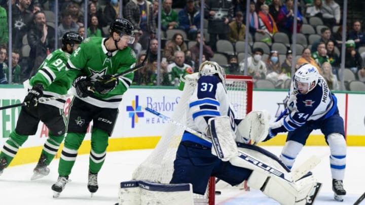 Feb 23, 2022; Dallas, Texas, USA; Winnipeg Jets goaltender Connor Hellebuyck (37) gives up the game winning goal on a shot by Dallas Stars center Tyler Seguin (91) as Stars defenseman Miro Heiskanen (4) and Jets defenseman Josh Morrissey (44) during the overtime period at the American Airlines Center. Mandatory Credit: Jerome Miron-USA TODAY Sports