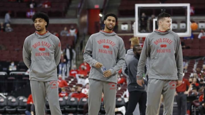 Injured Ohio State Buckeyes, from left, Justice Sueing, Seth Towns and forward Kyle Young (25) watch teammates warm up prior to the NCAA exhibition basketball game against the Indianapolis Greyhounds at Value City Arena in Columbus on Monday, Nov. 1, 2021.University Of Indianapolis At Ohio State Buckeyes