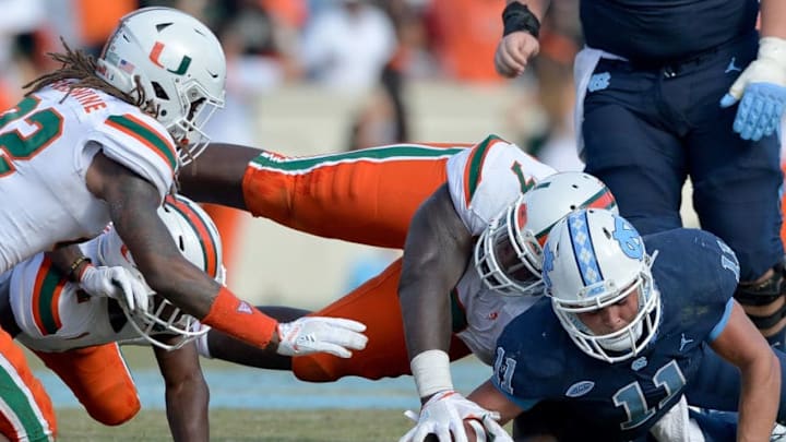 CHAPEL HILL, NC - OCTOBER 28: Kendrick Norton #7 of the Miami Hurricanes recovers a fumble by Nathan Elliott #11 of the North Carolina Tar Heels during their game at Kenan Stadium on October 28, 2017 in Chapel Hill, North Carolina. Miami won 24-19. (Photo by Grant Halverson/Getty Images)