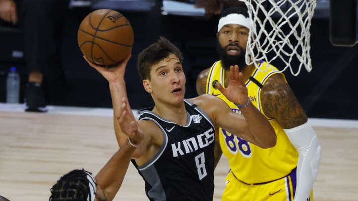 LAKE BUENA VISTA, FLORIDA – AUGUST 13: Bogdan Bogdanovic #8 of the Sacramento Kings goes up for a shot against JaVale McGee #7 and Markieff Morris #88 of the Los Angeles Lakers during the first quarter at The Field House at ESPN Wide World Of Sports Complex on August 13, 2020 in Lake Buena Vista, Florida. NOTE TO USER: User expressly acknowledges and agrees that, by downloading and or using this photograph, User is consenting to the terms and conditions of the Getty Images License Agreement. (Photo by Kevin C. Cox/Getty Images)