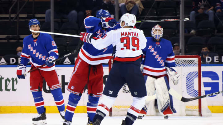 May 5, 2021; New York, New York, USA; Pavel Buchnevich #89 of the New York Rangers takes a high-sticking penalty on Anthony Mantha #39 of the Washington Capitals during the second period at Madison Square Garden. Mandatory Credit: Bruce Bennett/POOL PHOTOS-USA TODAY Sports