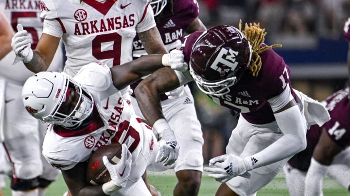 Sep 24, 2022; Arlington, Texas, USA; Arkansas Razorbacks running back Rashod Dubinion (6) is thrown to the ground by Texas A&M Aggies defensive back Jaylon Jones (17) during the second half at AT&T Stadium. Mandatory Credit: Jerome Miron-USA TODAY Sports