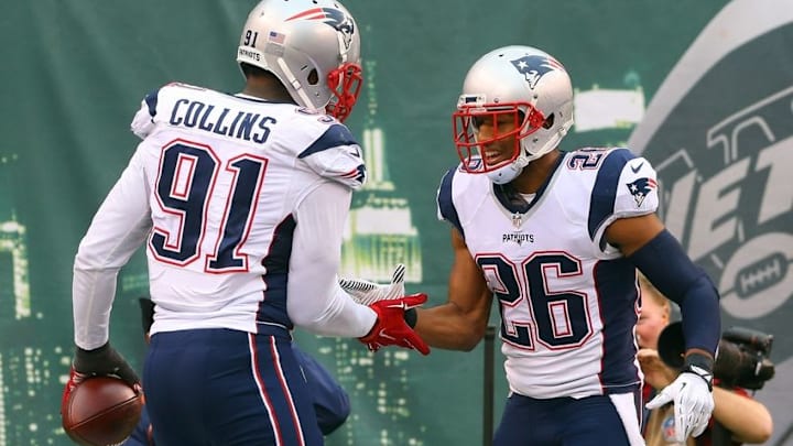 Dec 27, 2015; East Rutherford, NJ, USA; New England Patriots outside linebacker Jamie Collins (91) and New England Patriots cornerback Logan Ryan (26) celebrate a fumble return for a touchdown by Collins