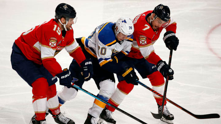 SUNRISE, FL - FEBRUARY 5: Riley Sheahan #15 and Colton Sceviour #7 of the Florida Panthers skates for possession against Oskar Sundqvist #70 of the St. Louis Blues at the BB&T Center on February 5, 2019 in Sunrise, Florida. (Photo by Eliot J. Schechter/NHLI via Getty Images)