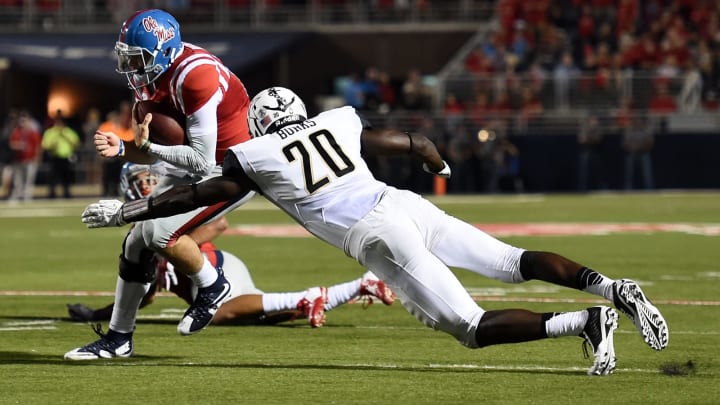 OXFORD, MS – SEPTEMBER 26: Chad Kelly #10 of the Mississippi Rebels avoids a tackle by Oren Burks #20 of the Vanderbilt Commodores during the fourth quarter of a game at Vaught-Hemingway Stadium on September 26, 2015 in Oxford, Mississippi. (Photo by Stacy Revere/Getty Images)