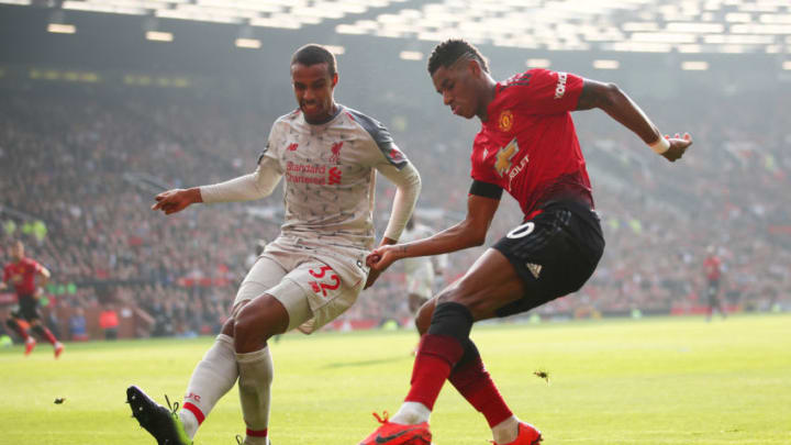 MANCHESTER, ENGLAND - FEBRUARY 24: Marcus Rashford of Manchester United looks to cross the ball under pressure from Joel Matip of Liverpool during the Premier League match between Manchester United and Liverpool FC at Old Trafford on February 24, 2019 in Manchester, United Kingdom. (Photo by Clive Brunskill/Getty Images)