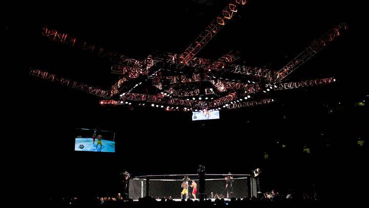 Fighters square off inside the octagon during their bout at Ultimate Fighting Championship (UFC) Fight Night at Cotai Arena, inside the Venetian Macao resort and casino, operated by Sands China Ltd., a unit of Las Vegas Sands Corp., in Macau, China, on Saturday, Aug. 23, 2014. UFC, the largest pay-per-view event provider, broadcasts to more than 800 million homes worldwide. Photographer: Brent Lewin/Bloomberg via Getty Images
