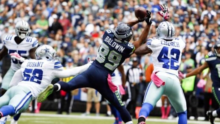 Oct 12, 2014; Seattle, WA, USA; Seattle Seahawks wide receiver Doug Baldwin (89) fails to make a touchdown reception while under coverage from Dallas Cowboys outside linebacker Justin Durant (52) and Dallas Cowboys free safety Barry Church (42) during the first quarter at CenturyLink Field. Mandatory Credit: Joe Nicholson-USA TODAY Sports