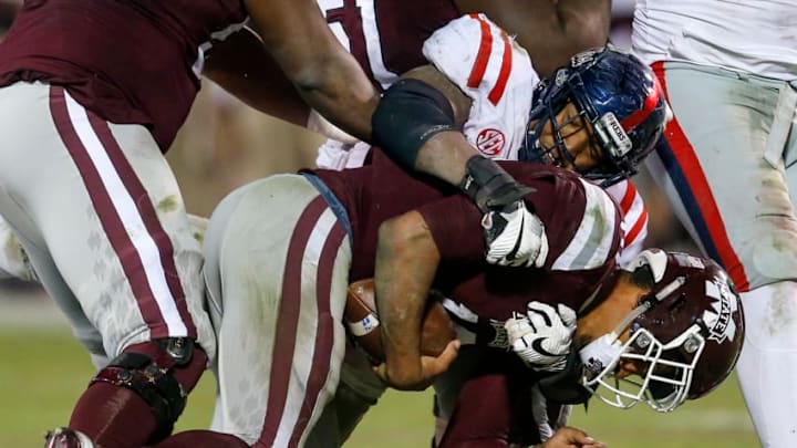 STARKVILLE, MS - NOVEMBER 23: Keytaon Thompson #10 of the Mississippi State Bulldogs is sacked by Breeland Speaks #9 of the Mississippi Rebels during the second half of an NCAA football game at Davis Wade Stadium on November 23, 2017 in Starkville, Mississippi. (Photo by Butch Dill/Getty Images)