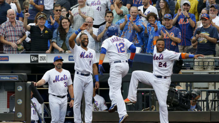 NEW YORK, NEW YORK - SEPTEMBER 12: Juan Lagares #12 of the New York Mets celebrates his third inning grand slam home run against the Arizona Diamondbacks with teammates Amed Rosario #1 and Robinson Cano #24 and manager Mickey Callaway #36 at Citi Field on September 12, 2019 in New York City. (Photo by Jim McIsaac/Getty Images)