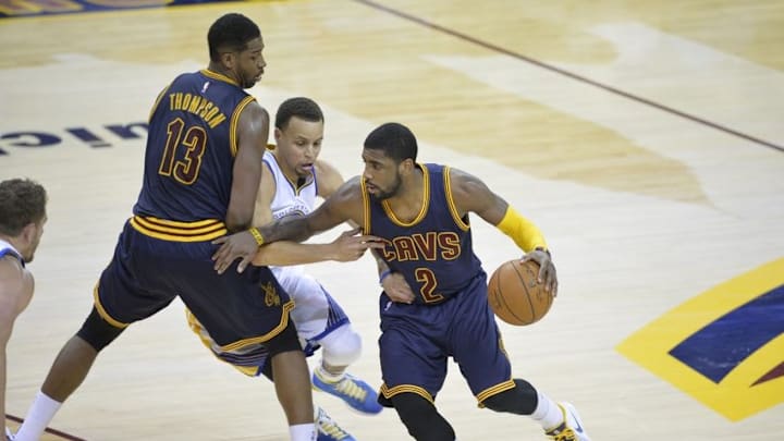 Feb 26, 2015; Cleveland, OH, USA; Cleveland Cavaliers guard Kyrie Irving (2) uses a pick by center Tristan Thompson (13) while driving against Golden State Warriors guard Stephen Curry (30) in the fourth quarter at Quicken Loans Arena. Mandatory Credit: David Richard-USA TODAY Sports