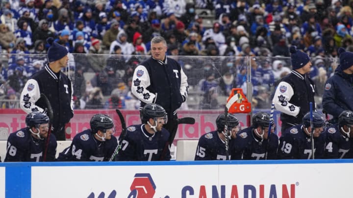 Mar 13, 2022; Hamilton, Ontario, CAN; Toronto Maple Leafs head coach Sheldon Keefe stands in the bench during the first period against the Buffalo Sabres in the 2022 Heritage Classic ice hockey game at Tim Hortons Field. Mandatory Credit: John E. Sokolowski-USA TODAY Sports