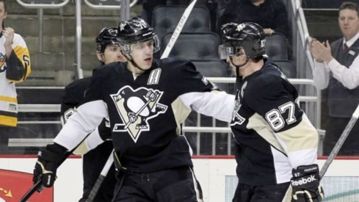 Mar 22, 2014; Pittsburgh, PA, USA; Pittsburgh Penguins center Evgeni Malkin (71) congratulates center Sidney Crosby (87) after Crosby scored a goal against the Tampa Bay Lightning during the second period at the CONSOL Energy Center. Mandatory Credit: Charles LeClaire-USA TODAY Sports