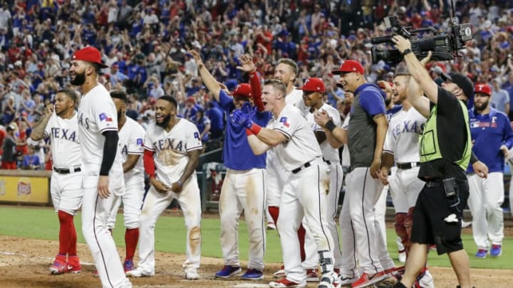 ARLINGTON, TX - AUGUST 03: Texas Rangers second baseman Rougned Odor (12) celebrates at home plate with his teammates after hitting the game winning home run during the game between the Texas Rangers and the Detroit Tigers on August 03, 2019 at Globe Life Park in Arlington, Texas. (Photo by Matthew Pearce/Icon Sportswire via Getty Images)