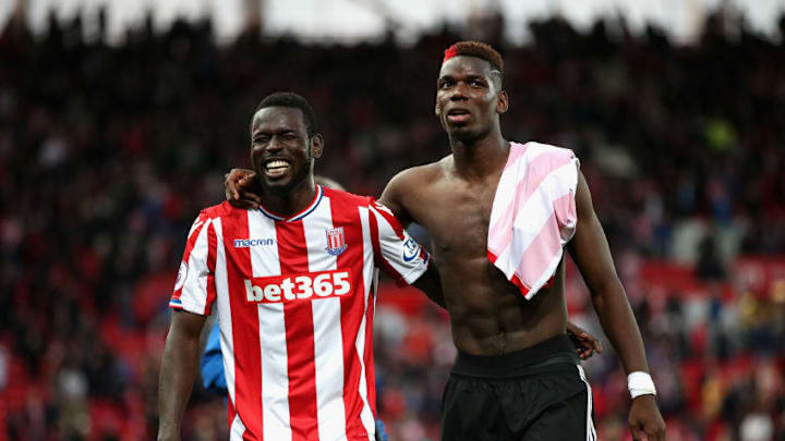 STOKE ON TRENT, ENGLAND - SEPTEMBER 09: Mame Biram Diouf of Stoke City and Paul Pogba of Manchester United leave the pitch during the Premier League match between Stoke City and Manchester United at Bet365 Stadium on September 9, 2017 in Stoke on Trent, England. (Photo by Alex Morton/Getty Images)