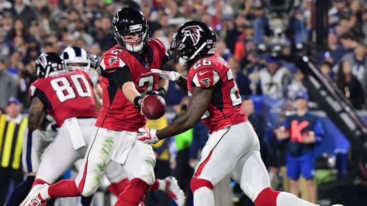 LOS ANGELES, CA - JANUARY 06: Quarterback Matt Ryan #2 of the Atlanta Falcons hands offsides to teammate running back Tevin Coleman #26 during the second quarter of the NFC Wild Card Playoff game against the Los Angeles Rams at Los Angeles Coliseum on January 6, 2018 in Los Angeles, California. (Photo by Harry How/Getty Images)