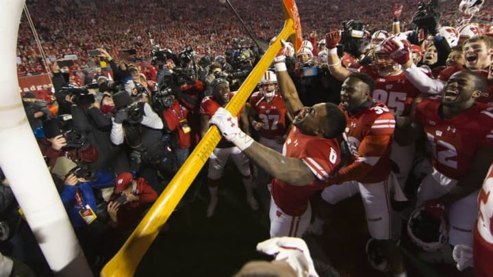Nov 26, 2016; Madison, WI, USA; Wisconsin Badgers running back Corey Clement (6) celebrates with the Paul Bunyan Football Trophy following the game against the Minnesota Golden Gophers at Camp Randall Stadium. Wisconsin won 31-17. Mandatory Credit: Jeff Hanisch-USA TODAY Sports