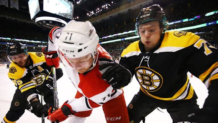 BOSTON, MA - FEBRUARY 27: Lucas Wallmark #71 of the Carolina Hurricanes fights for the puck with David Krejci #46 and Charlie McAvoy #73 of the Boston Bruins during a game at TD Garden on February 27, 2018 in Boston, Massachusetts. NOTE TO USER: User expressly acknowledges and agrees that, by downloading and or using this photograph, User is consenting to the terms and conditions of the Getty Images License Agreement. (Photo by Adam Glanzman/Getty Images)