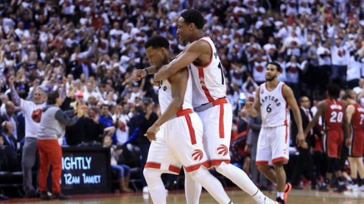 TORONTO, ON - MAY 15: DeMar DeRozan #10 and Kyle Lowry #7 of the Toronto Raptors celebrate late in the second half of Game Seven of the Eastern Conference Quarterfinals against the Miami Heat during the 2016 NBA Playoffs at the Air Canada Centre on May 15, 2016 in Toronto, Ontario, Canada. NOTE TO USER: User expressly acknowledges and agrees that, by downloading and or using this photograph, User is consenting to the terms and conditions of the Getty Images License Agreement. (Photo by Vaughn Ridley/Getty Images)