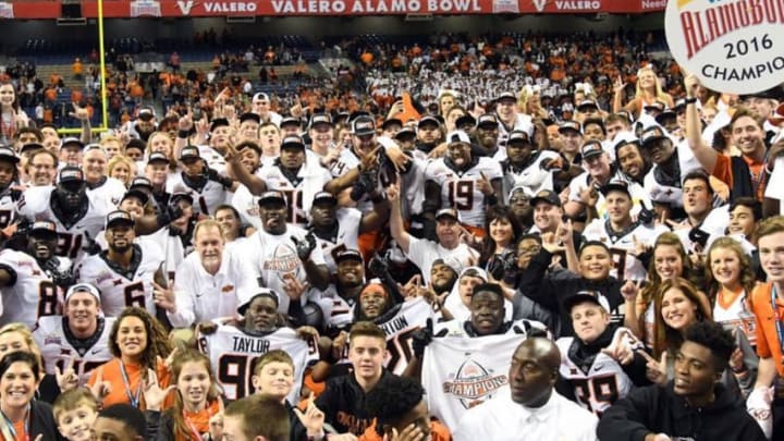 Dec 29, 2016; San Antonio, TX, USA; Oklahoma State Cowboys players and coach Mike Van Gundy celebrate after the 2016 Alamo Bowl against the Colorado Buffaloes at Alamodome. Oklahoma State defeated Colorado 38-8. Mandatory Credit: Kirby Lee-USA TODAY Sports