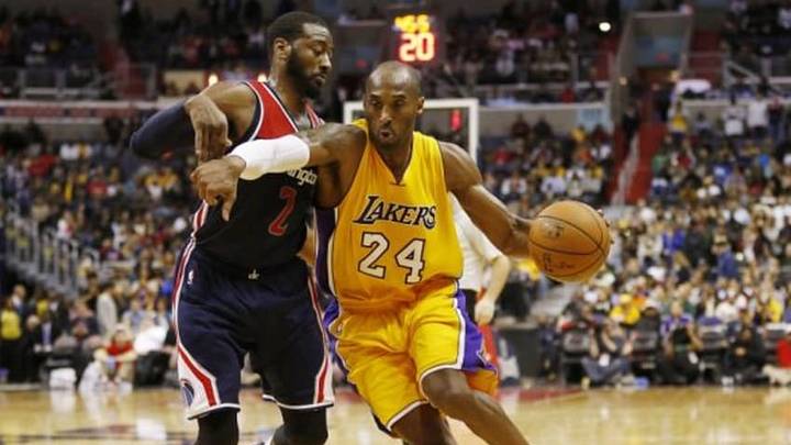Dec 3, 2014; Washington, DC, USA; Los Angeles Lakers guard Kobe Bryant (24) dribbles the ball as Washington Wizards guard John Wall (2) defends in the fourth quarter at Verizon Center. The Wizards won 111-95. Mandatory Credit: Geoff Burke-USA TODAY Sports