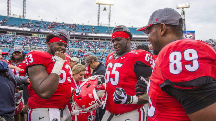 Jan 2, 2016; Jacksonville, FL, USA; Georgia Bulldogs guard Lamont Gaillard (53) and offensive tackle Kendall Baker (65) and defensive tackle James DeLoach (89) celebrate after a game against the Penn State Nittany Lions at EverBank Field. The Georgia Bulldogs defeated Penn State Nittany Lions 24-17 to win the 2016 TaxSlayer Bowl. Mandatory Credit: Logan Bowles-USA TODAY Sports