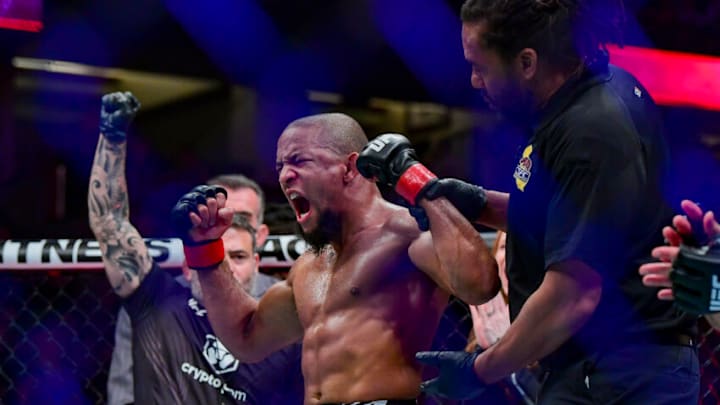 Jan 22, 2022; Anaheim, California, USA; Tony Gravely (red gloves) celebrates his win by unanimous decision against Saimon Oliveira (blue gloves) during UFC 270 at Honda Center. Mandatory Credit: Gary A. Vasquez-USA TODAY Sports