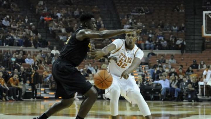 Dec 20, 2014; Austin, TX, USA; Texas Longhorns forward Myles Turner (52) passes around Long Beach State 49ers forward Temidayo Yussuf (left) during the first half at the Frank Erwin Special Events Center. Mandatory Credit: Brendan Maloney-USA TODAY Sports