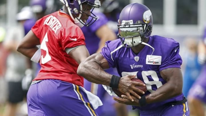 Jul 27, 2015; Mankato, MN, USA; Minnesota Vikings quarterback Teddy Bridgewater (5) hands off the ball to running back Adrian Peterson (28) in drills at training camp at Minnesota State University. Mandatory Credit: Bruce Kluckhohn-USA TODAY Sports