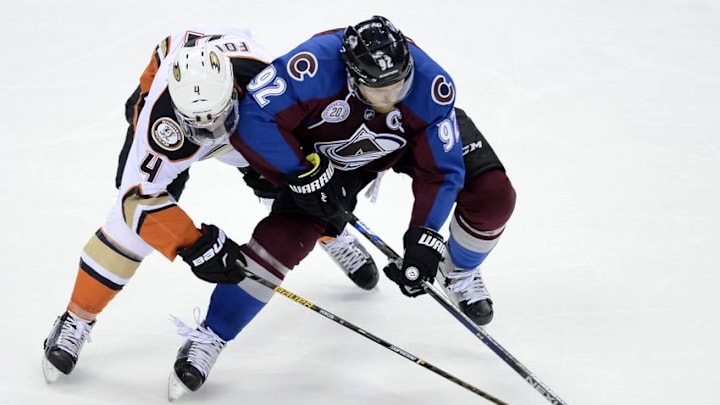 Mar 9, 2016; Denver, CO, USA; Anaheim Ducks defenseman Cam Fowler (4) and Colorado Avalanche left wing Gabriel Landeskog (92) battle for control of the puck in the first period at the Pepsi Center. Mandatory Credit: Ron Chenoy-USA TODAY Sports