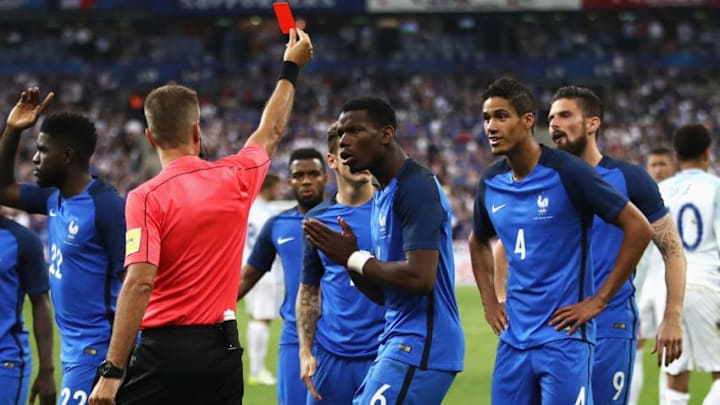 PARIS, FRANCE - JUNE 13: Paul Pogba of France (6) reacts as Raphael Varane of France (4) is shown a red card and is sent off by referee Davide Massa during the International Friendly match between France and England at Stade de France on June 13, 2017 in Paris, France. (Photo by Julian Finney/Getty Images)