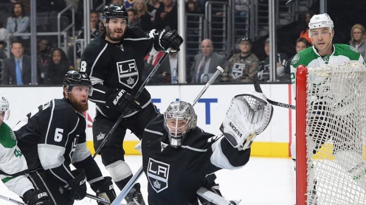 Apr 2, 2016; Los Angeles, CA, USA; Los Angeles Kings defenseman Drew Doughty (8) and defenseman Jake Muzzin (6) look on as goalie Jonathan Quick (32) reaches for a puck in the first period of the game against the Dallas Stars at Staples Center. Mandatory Credit: Jayne Kamin-Oncea-USA TODAY Sports