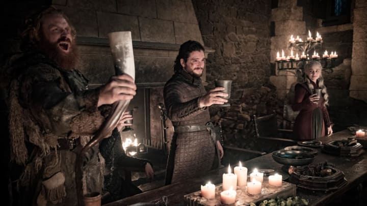 Kristofer Hivju, Kit Harington, and Emilia Clarke celebrate in Game of Thrones