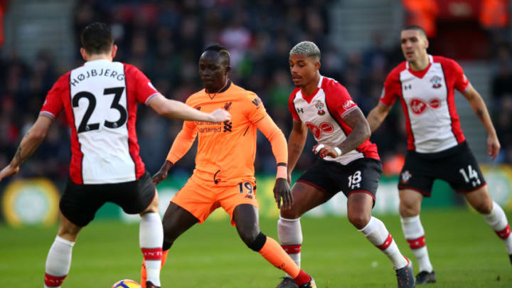 SOUTHAMPTON, ENGLAND - FEBRUARY 11: Sadio Mane of Liverpool runs with the ball under pressure from Pierre-Emile Hojbjerg of Southampton and Mario Lemina of Southampton during the Premier League match between Southampton and Liverpool at St Mary's Stadium on February 11, 2018 in Southampton, England. (Photo by Julian Finney/Getty Images)