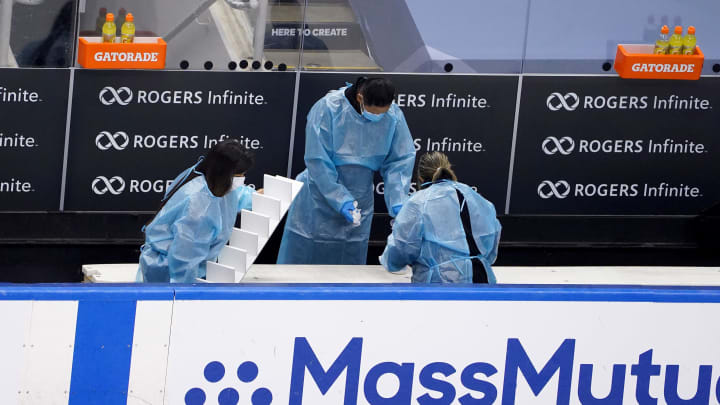 TORONTO, ONTARIO – AUGUST 09: Staff members disinfect and clean the benches after an Eastern Conference Round Robin game between the Boston Bruins and the Washington Capitals during the 2020 NHL Stanley Cup Playoffs at Scotiabank Arena on August 09, 2020 in Toronto, Ontario, Canada. (Photo by Andre Ringuette/Freestyle Photo/Getty Images)