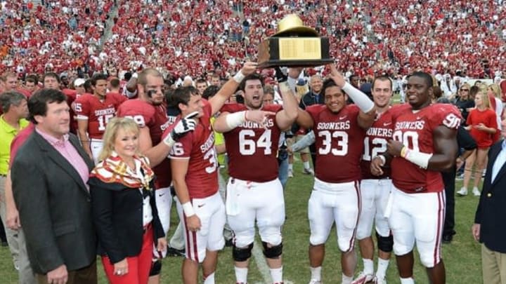 OCT 13, 2012; Dallas, TX, USA; Oklahoma governor Mary Fallin with Oklahoma Sooners players from left including lineman Lane Johnson (69) Tress Way (36) , center Gabe Ikard (64) , running back Trey Millard (33) , quarterback Landry Jones (12) and defensive end David King (90) pose with the golden hat trophy after the game against the Texas Longhorns during the red river rivalry at the Cotton Bowl. The Sooners beat the Longhorns 63-21. Mandatory Credit: Matthew Emmons-USA TODAY Sports