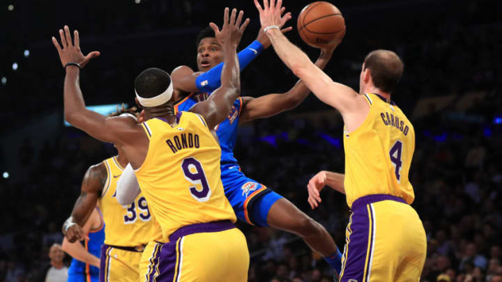 Shai Gilgeous-Alexander #2 of the OKC Thunder passes the ball past the defense of Rajon Rondo #9 and Alex Caruso #4 of the Los Angeles Lakers. (Photo by Sean M. Haffey/Getty Images)