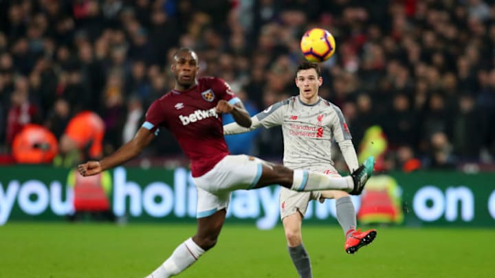 LONDON, ENGLAND - FEBRUARY 04: Andy Robertson of Liverpool shoots while challenged by Michail Antonio of West Ham United during the Premier League match between West Ham United and Liverpool FC at London Stadium on February 04, 2019 in London, United Kingdom. (Photo by Catherine Ivill/Getty Images)