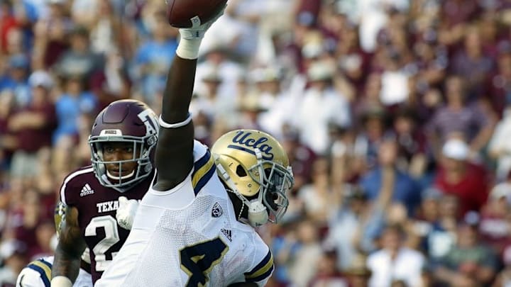 Sep 3, 2016; College Station, TX, USA; UCLA Bruins running back Bolu Olorunfunmi (4) celebrates his nine-yard touchdown run against the Texas A&M Aggies during the second half at Kyle Field. Texas A&M won in overtime 31-24. Mandatory Credit: Ray Carlin-USA TODAY Sports