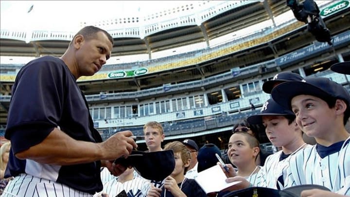 Aug 14, 2013; Bronx, NY, USA; New York Yankees third baseman Alex Rodriguez (13) signs autographs for fans before the game against the Los Angeles Angels at Yankee Stadium. Mandatory Credit: Debby Wong-USA TODAY Sports