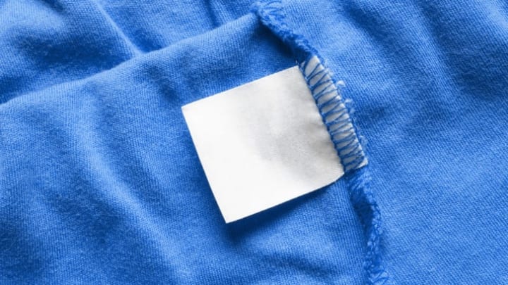 A blue item of clothing inside out with the blank tag showing.
