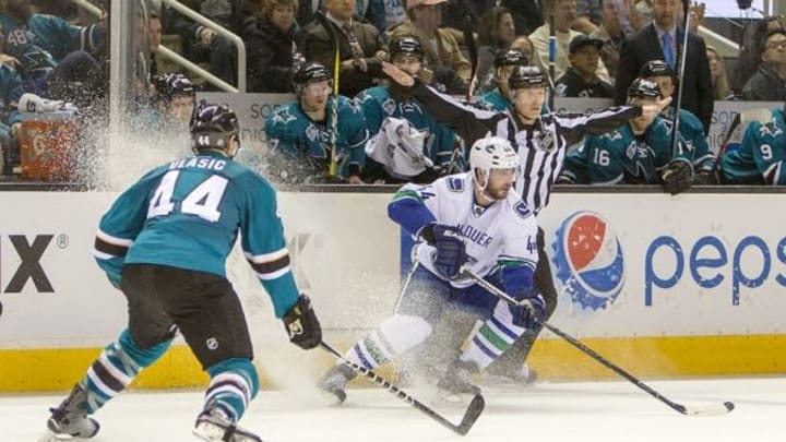 Mar 5, 2016; San Jose, CA, USA; Vancouver Canucks defenseman Matt Bartkowski (44) controls the puck against San Jose Sharks defenseman Marc-Edouard Vlasic (44) in the third period at SAP Center at San Jose. San Jose Sharks lose to Vancouver Canucks 2 to 4. Mandatory Credit: Neville E. Guard-USA TODAY Sports