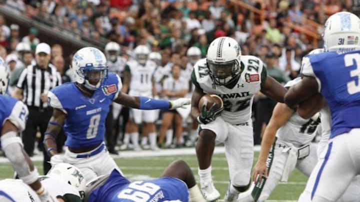 Dec 24, 2016; Honolulu, HI, USA; Hawaii Warriors running back Diocemy Saint Juste (22) runs through the Middle Tennessee Blue Raiders defense during the third quarter at Hawaiian Tel Federal Credit Union Field. Mandatory Credit: Marco Garcia-USA TODAY Sports