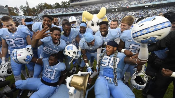 Nov 7, 2015; Chapel Hill, NC, USA; North Carolina Tar players celebrate with the Victory Bell after the game. The Tar Heels defeated the Blue Devils 66-31 at Kenan Memorial Stadium. Mandatory Credit: Bob Donnan-USA TODAY Sports