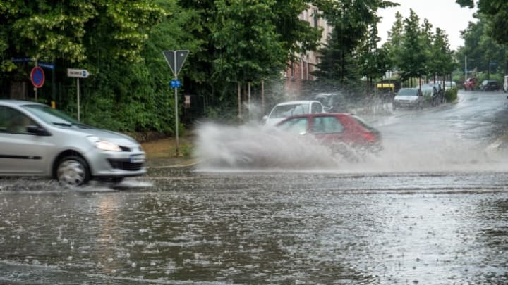 Flooded street with splashing cars