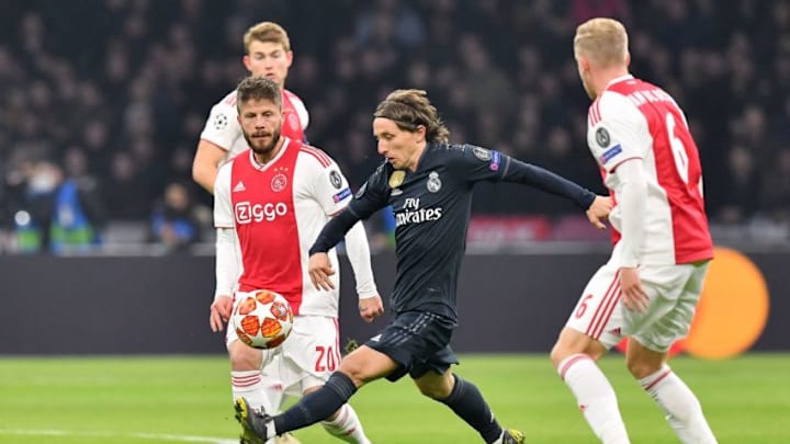 Real Madrid’s Croatian midfielder Luka Modric (C) fights for the ball with Ajax’s Danish midfielder Lasse Schone (L) and Ajax’s Dutch midfielder Donny van de Beek (R) during the UEFA Champions league round of 16 first leg football match between Ajax Amsterdam and Real Madrid at the Johan Cruijff ArenA on February 13, 2019. (Photo by EMMANUEL DUNAND / AFP) (Photo credit should read EMMANUEL DUNAND/AFP/Getty Images)