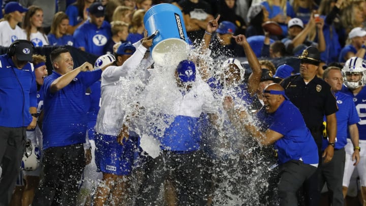 Sep 11, 2021; Provo, Utah, USA; Brigham Young Cougars head coach Kalani Sitake is dowsed in ice water as they celebrate during the final seconds of their game, beating the Utah Utes at LaVell Edwards Stadium. Mandatory Credit: Jeffrey Swinger-USA TODAY Sports