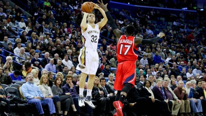 Feb 2, 2015; New Orleans, LA, USA; New Orleans Pelicans guard Jimmer Fredette (32) shoots over Atlanta Hawks guard Dennis Schroder (17) during the first quarter of a game at the Smoothie King Center. The Pelicans defeated the Hawks 115-100. Mandatory Credit: Derick E. Hingle-USA TODAY Sports